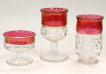 1090: 33 piece cranberry and clear stem ware, thumbprin