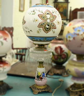 Victorian kerosene table lamp, white milk glass p: Victorian kerosene table lamp, white milk glass pedestal, reticulated cast iron base, pattern glass font, large ball shade, 22"t. Has paint lose. ………………We are a live "brick/mortar"