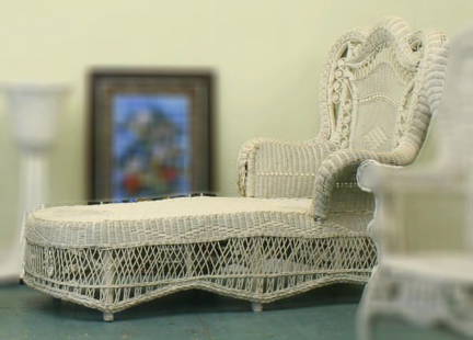 Mid 1900 Victorian style wicker chaise, 48"t sc: Mid 1900 Victorian style wicker chaise, 48"t scalloped rolled backs and arm, open arch center with curly-que decorations, 70"l 36"w. Damage to upper right roll side and lower left rolled