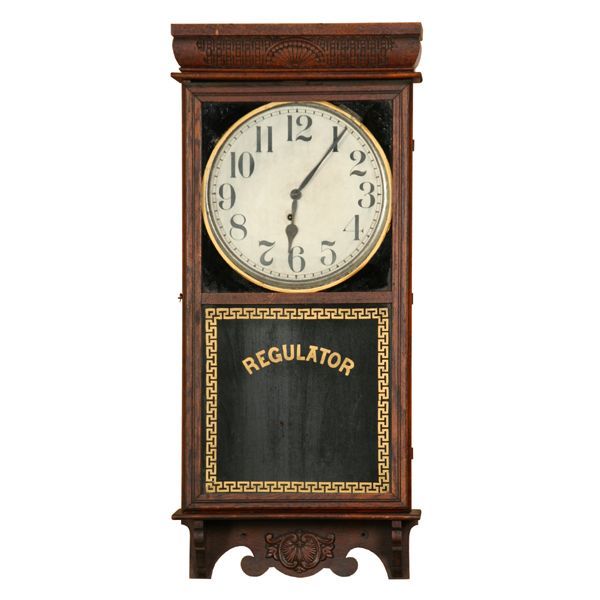 Early 1900 regulator wall clock, E. Ingraham Co.,: Early 1900 regulator wall clock, E. Ingraham Co., Western Union model 1911, time only, solid oak, ebonized and gold letter, carved molded crown, carved bracket base, 36"t 16"w 4 1/2"d. Original crazed