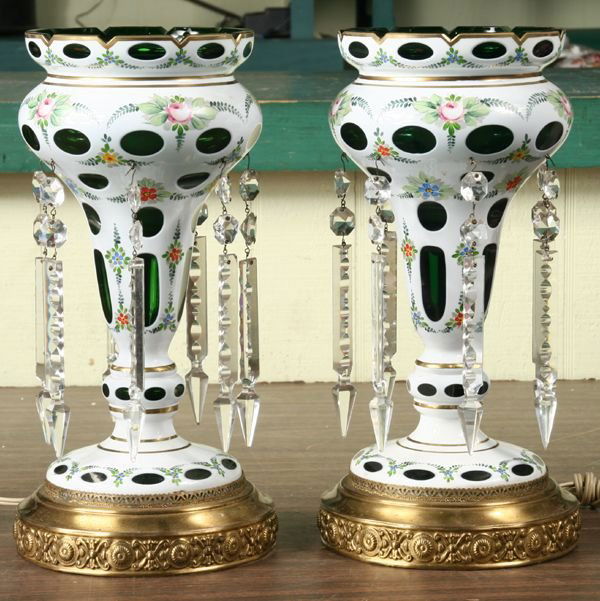 Pair of early 1900 mantle lusters, heavy emerald: Pair of early 1900 mantle lusters, heavy emerald cut glass, white cut to green, rose and floral handpainted decorations, cut prisms, reprousse brass bases, 14"t 7" diameter. Good condition, electrifie