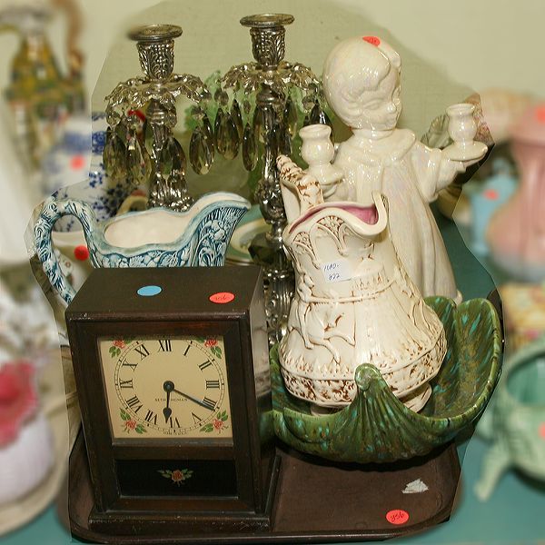 Nine pieces misc. lot 8"t Seth Thomas alarm cloc: Nine pieces misc. lot 8"t Seth Thomas alarm clock in wooden case, 2 ceramic pitchers, 2-15"t cast candle sticks with prisms, 1 large ceramic shell, 1-13" ceramic angel candle holder, 2 ceramic 8" doll