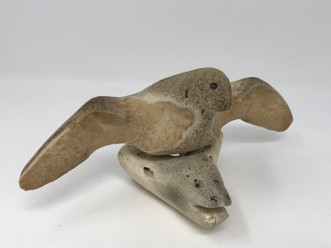 Inuit Eskimo Whale Bone Carving Flying Bird: Inuit Eskimo whale bone carving of flying bird numbered in the back. Measures 4 1/2 inches x 9 1/2 inches x 4 inches deep. Good condition.