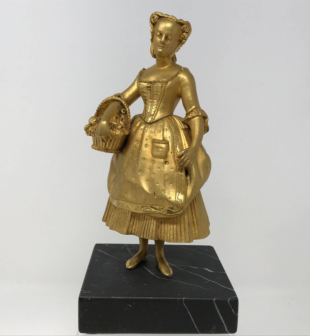 Bronze Ormolu Lady with Flower Basket: French Bronze Ormolu lady with flower basket sculpture. The sculpture is in good condition, it is missing the flower bouquet. The statue is mounted on black marble base, there are no chips, cracks or