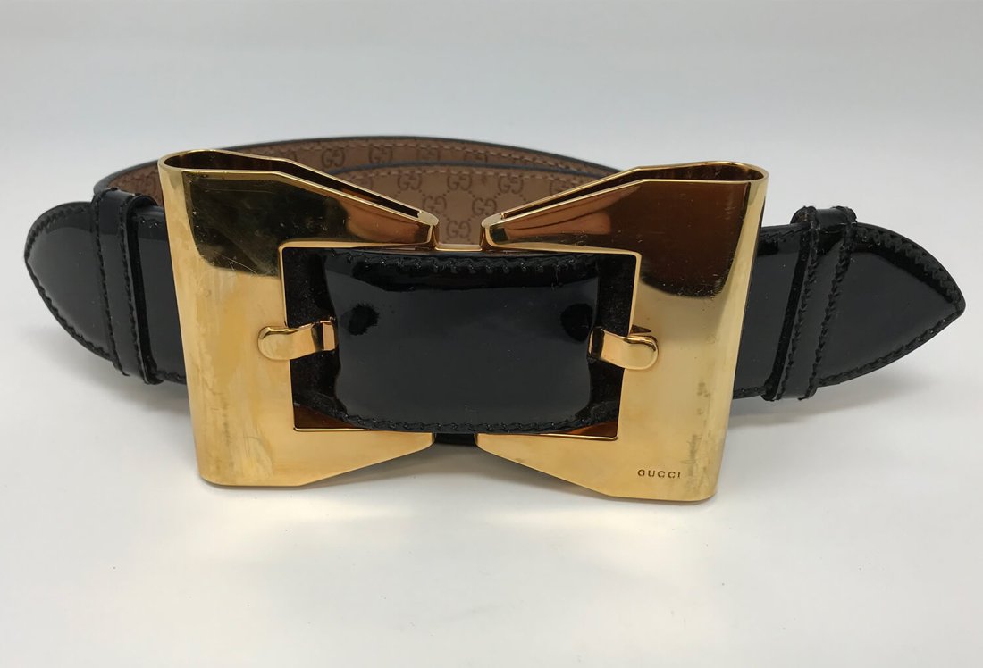 Black Gucci Bow Patent Leather Belt: Pre-owned black Gucci bow patent leather belt. It is gold tones and marked. Adjustable bow buckle closure and measures 30 inches x 32 inches long.