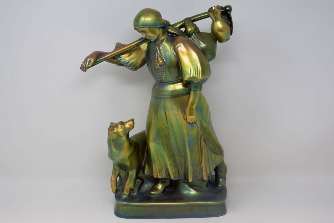 Zsolnay Hungary Eozin Woman with Dog 13 1/2 inches: Large Zsolnay Hungary Eozin woman with dog. Stamped and numbered at the base. Measures 13 1/2 inches tall x 7 1/4 inches x 4 inches at the base. Showing a hairline crack at the base.