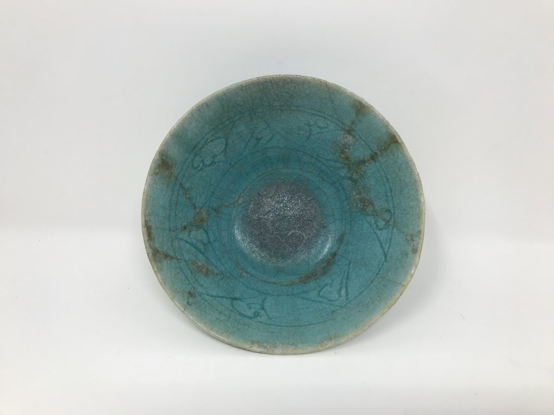 Kashan Ware 13th century Bowl: Kashan pottery bowl on a small foot covered with a turquoise glaze and design in the interior. Measures 15cm in diameter x 6cm tall.