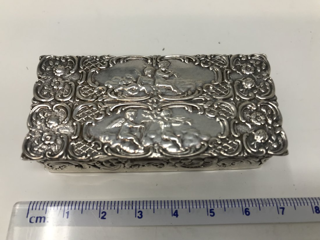 Vintage Sterling Silver Pills Box Goldwash: Sterling silver London hallmark rectangular pill box with embossed putty decoration marks and maker marks in the interior. Goldwash in the interior measures 6.8 cm long x 3.2 cm wide x 1.8cm high.