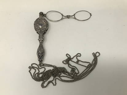 Victorian Sterling Silver Repousse Lorgnette: Victorian sterling silver repousse reading Lorgnette with art nouveau design and silver chain 68 inches long. Lorgnette measures 5 inches long marked on the loop.