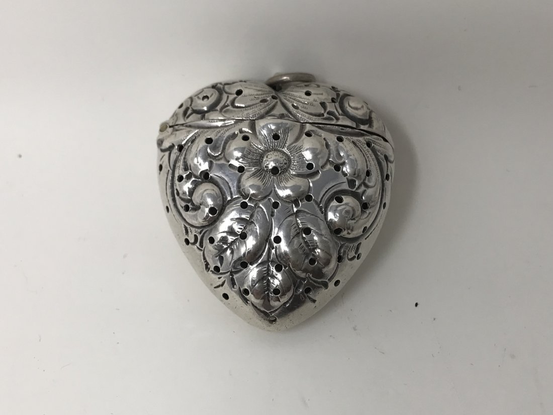 Victorian Sterling Silver Heart Shaped Vesta Case: Victorian sterling silver heart shaped vesta case with flip top and embossed flower decoration stamped sterling B. Measures 1 3/4 inches x 1 1/2 inches, in good condition.