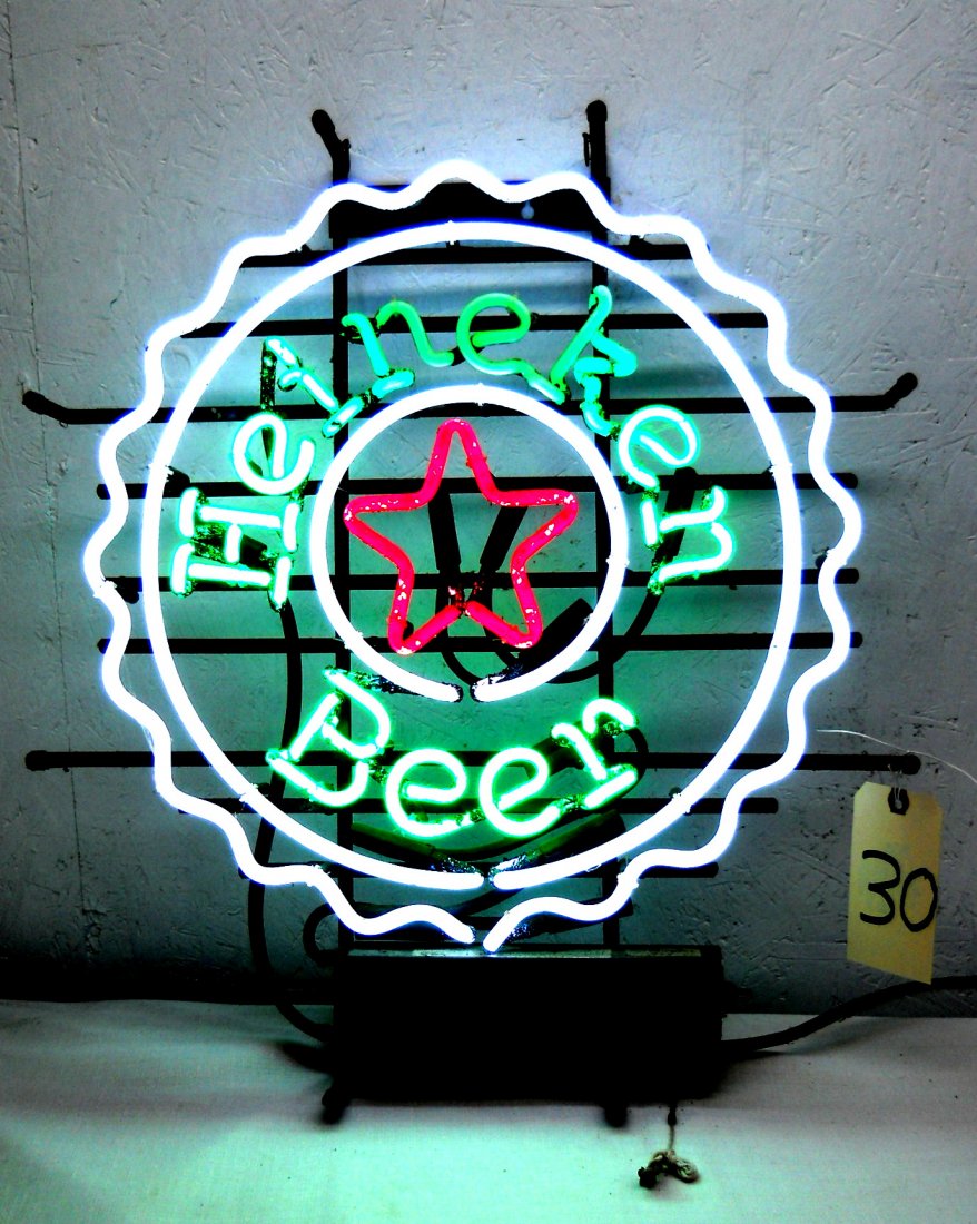 HEINEKEN BEER Neon Sign: Vintage HEINEKEN BEER Neon Sign. Bottle cap shaped Heineken beer neon sign. Green, white and red neon. No box. 24.5” H x 21.5” W