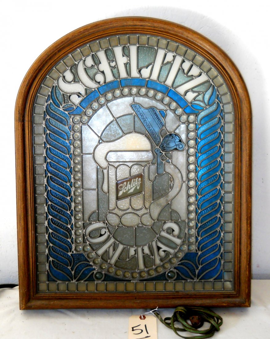 SCHLITZ BEER Faux Stained Glass Sign: Vintage SCHLITZ BEER Faux Stained Glass Sign. Light up sign. Reads, “Schlitz on Tap” Wood plastic frame. 25.5” H x 20.5” W Works.