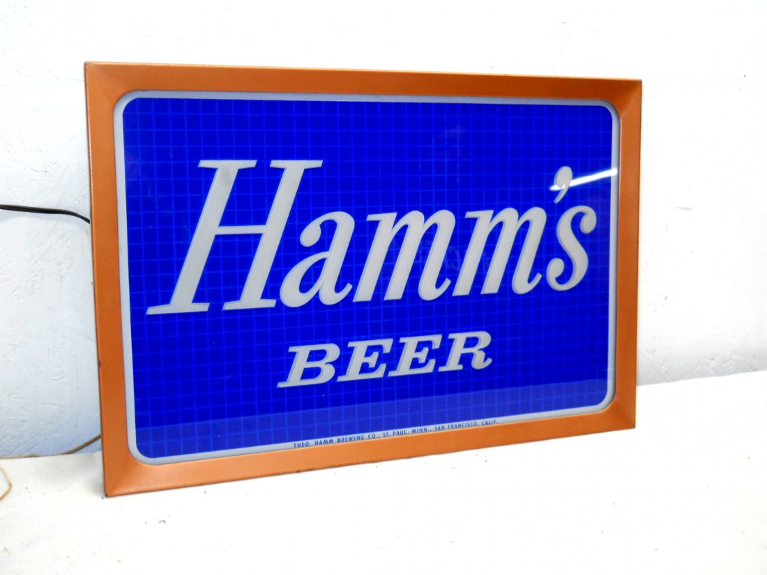 HAMM'S BEER Light Sign: Vintage HAMM'S Light Up advertisement sign (Identical to Lot #78). Metal frame, Blue glass logo, works! Additional logo/light on back, great condition. 20” H x 14” W x 2.5” D