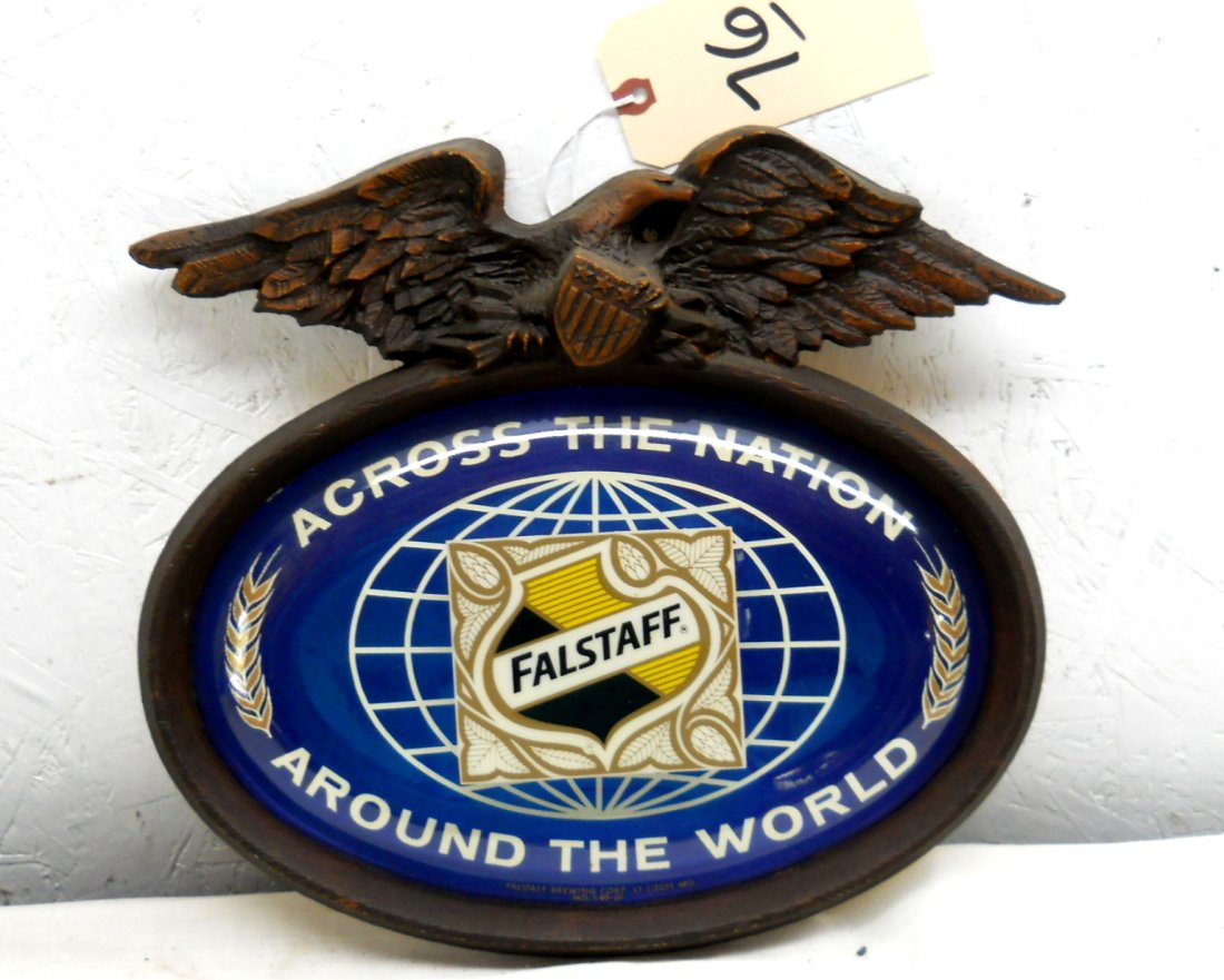 FALSTAFF BEER Wall Sign: Vintage small Falstaff wall advertisement sign with and eagle atop a blue ovel with Falstaff logo and the saying “Across the Nation, Around the World” with globe. Made from resin? 13” H x 14”