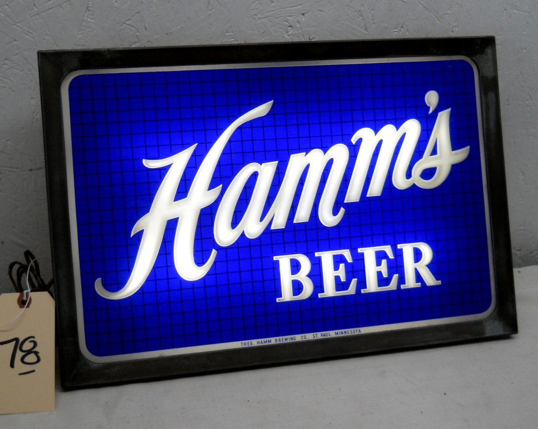 HAMM'S BEER Light Sign: Vintage HAMM'S BEER light up advertisement sign (Identical to Lot #59) with metal frame, Blue glass logo, works! Additional logo/light on back, great condition, some residual packaging glue on back pa
