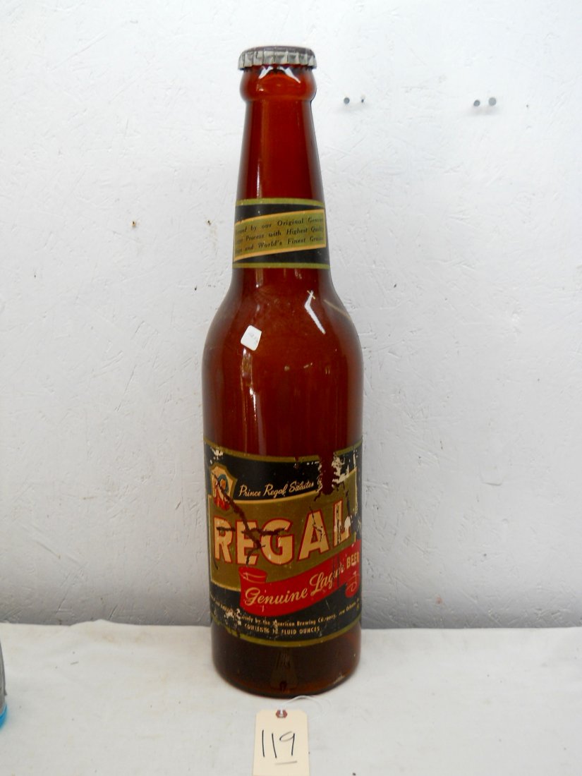 REGAL BEER - Jumbo Glass Beer Bottle: Vintage REGAL BEER bottle advertisement. Huge glass beer bottle with cap and Regal beer label. Label has losses, but in place and legible. 30” H x 7.5” diameter