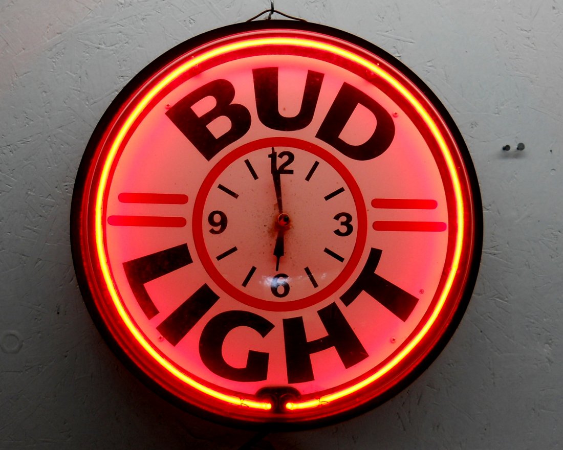 BUD LIGHT Wall Clock: Large vintage advertisement wall clock with BUD LIGHT written on clock face and red neon encircling the design. Neon works, clock may or may not work (there is no second hand, it's hard to say). 6”