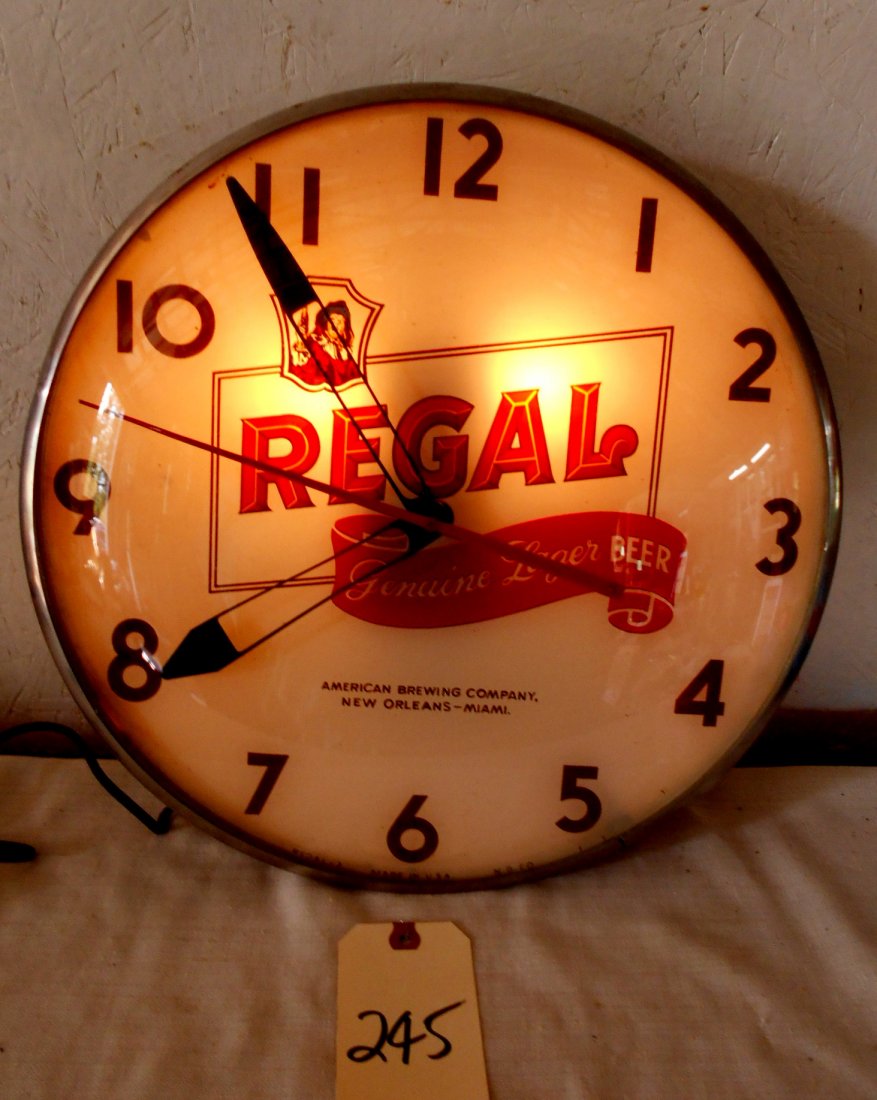 REGAL BEER Clock: Vintage REGAL BEER wall clock. Plastic and metal housing and glass dome. Regal logo on clock face. Light works and clock runs. Like new condition. 14.5" Diameter x 3.25" Deep. SEE VIDEO: