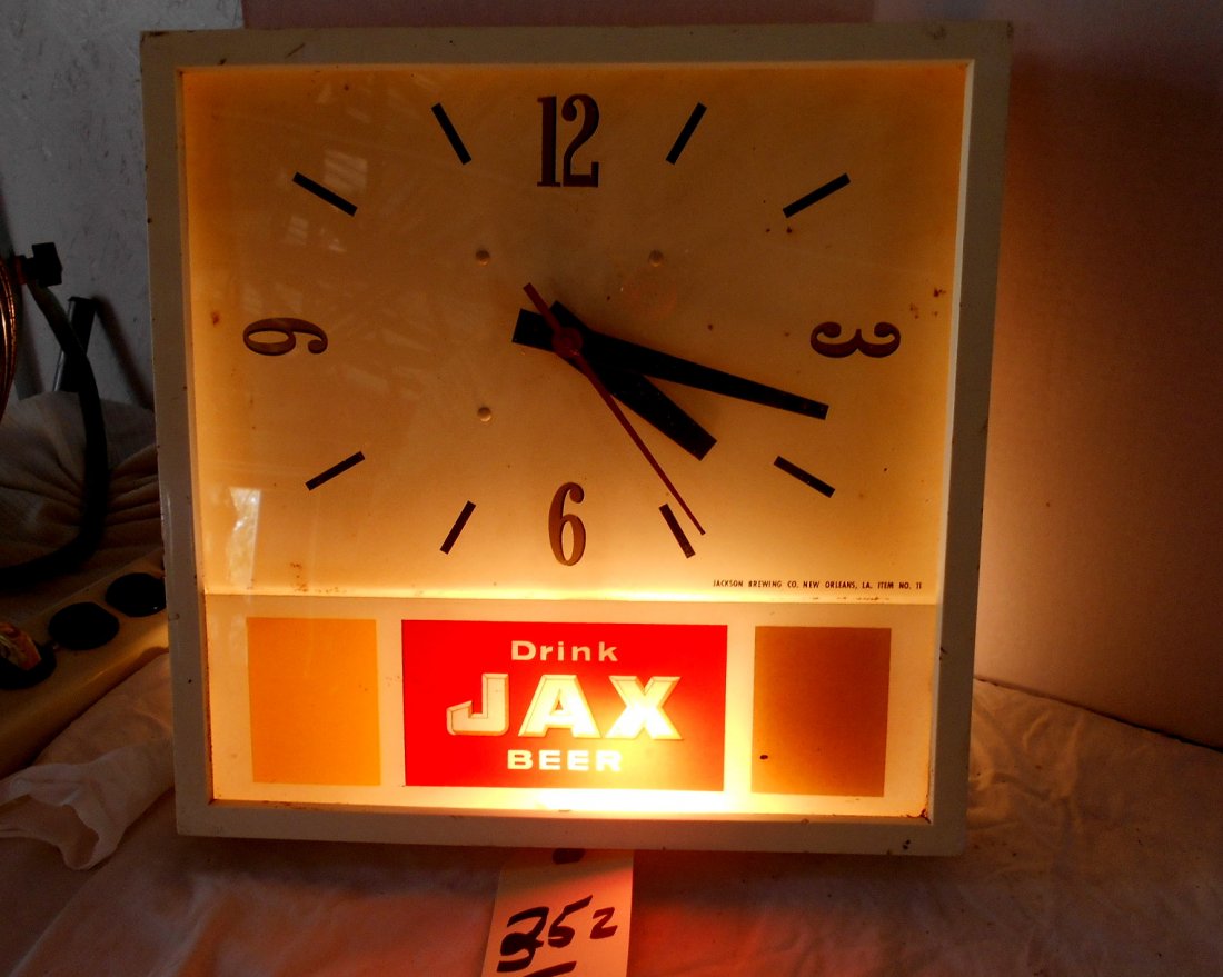 JAX BEER Clock: Vintage JAX BEER wall clock advertisement. White background. Lights up. Metal and platic case. Second hand moves when plugged in. 13.5"X13.5"X2.5". SEE VIDEO: