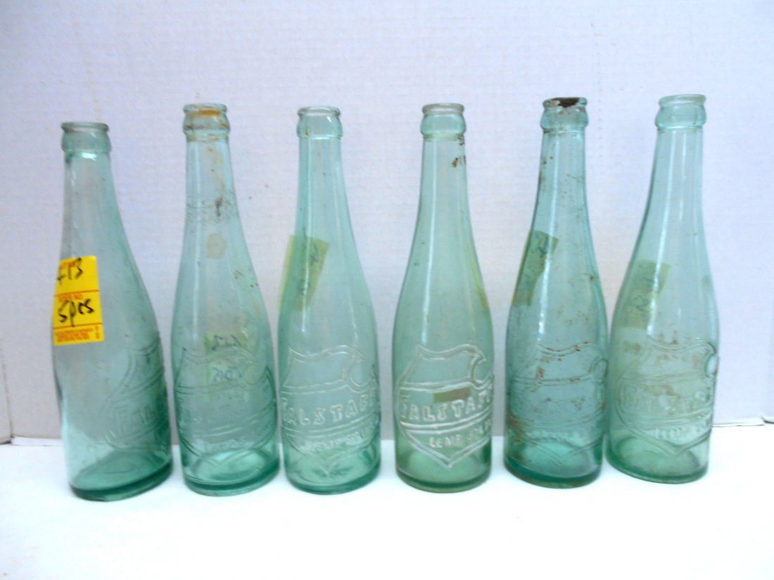 FALSTAFF BEER Green Bottles: 6 pcs. Vintage beer bottles. Embossed Falstaff shield on clear green glass bottles. 2 bottles with white highlights on graphic. No chips or cracks. 9.5"