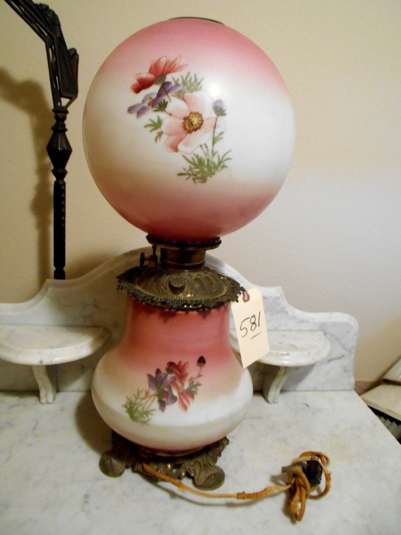Antique Gone with the Wind Table Lamp "“ Electrified: Large antique American antebellum oil lamp which has been electrified. With original kerosene reservoir. Heavy brass base and hardware. Hand painted rose motif. Brass ring around top of chimney openin