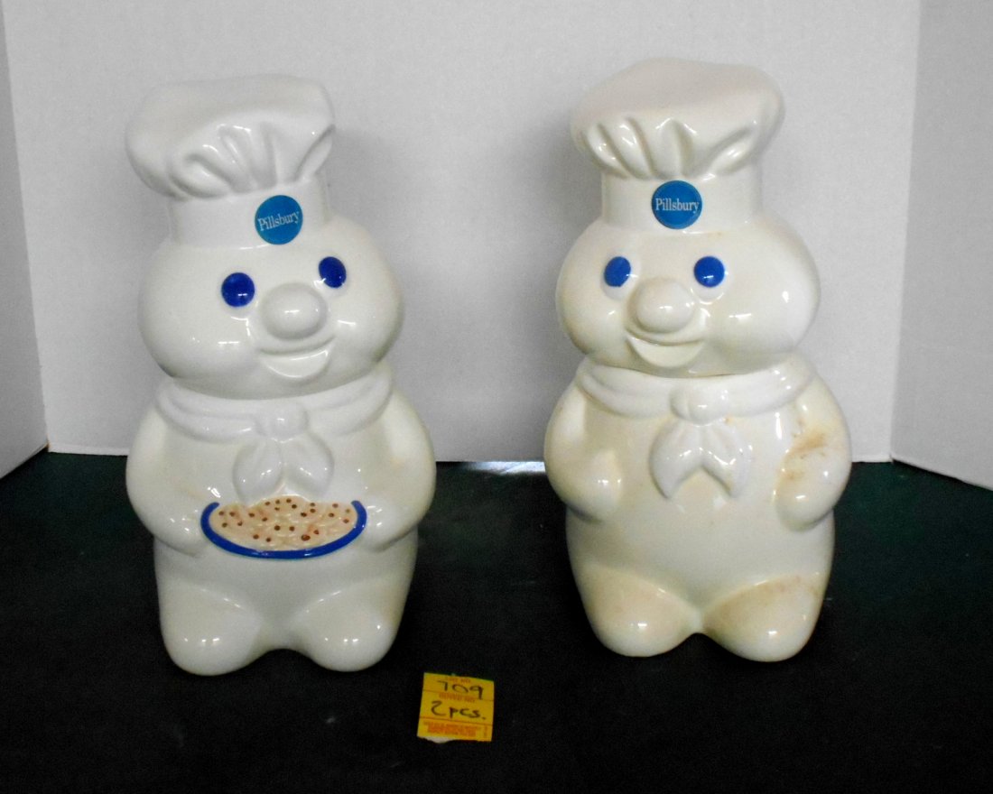 PILLSBURY DOUGHBOY Cookie Jars: 2 Pc.s Pillsbury Doughboy Cookie Jars, with original box. The one holding cookies is dated 1998, the other is dated 1988. 12" tall