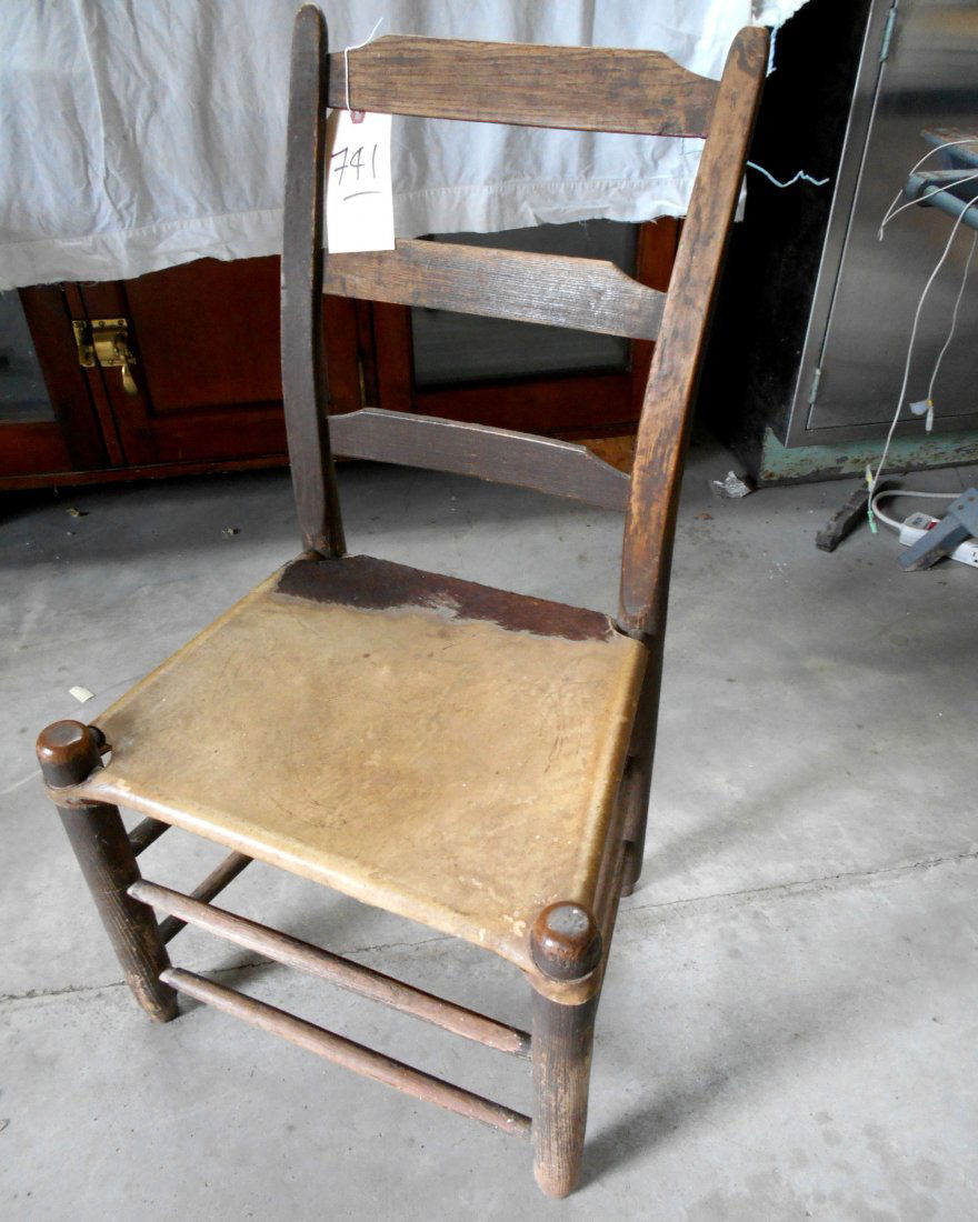 Primitive Antique Texas Chair: Primitive antique Texas table/side chair. Sturdy wood construction with rawhide seat. Ladder back with thumb top. 34 1/2" H x 18" W x 14 1/2" D.