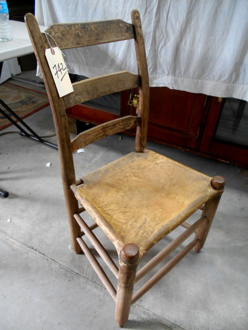 Primitive Antique Texas Chair: Primitive antique Texas table/side chair. Sturdy wood construction with rawhide seat. Ladder back with thumb top. 34 1/2" H x 18" W x 14 1/2" D.