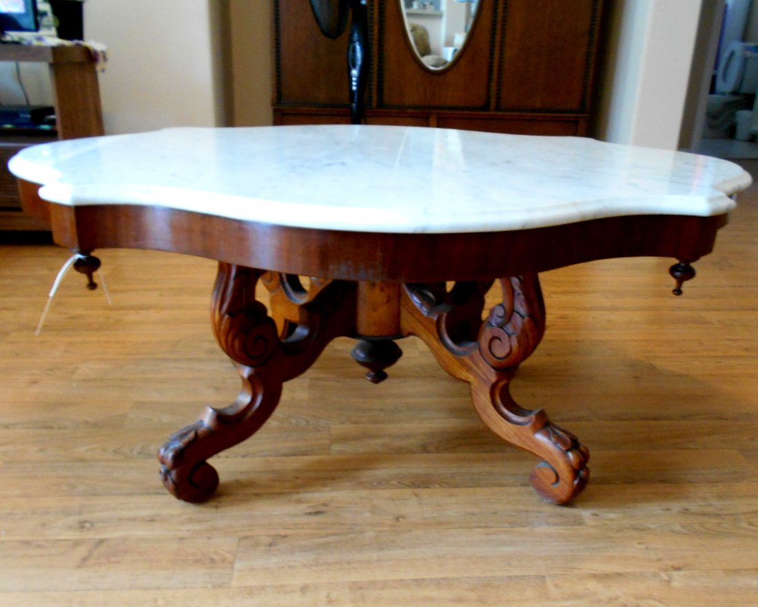 Antique American Victorian Coffee Table – Furniture: Large Antique American Victorian coffee Table. White marble turtle top. Drop finials. Casters gone missing. 21” tall. Top 49” x 37 1/2”