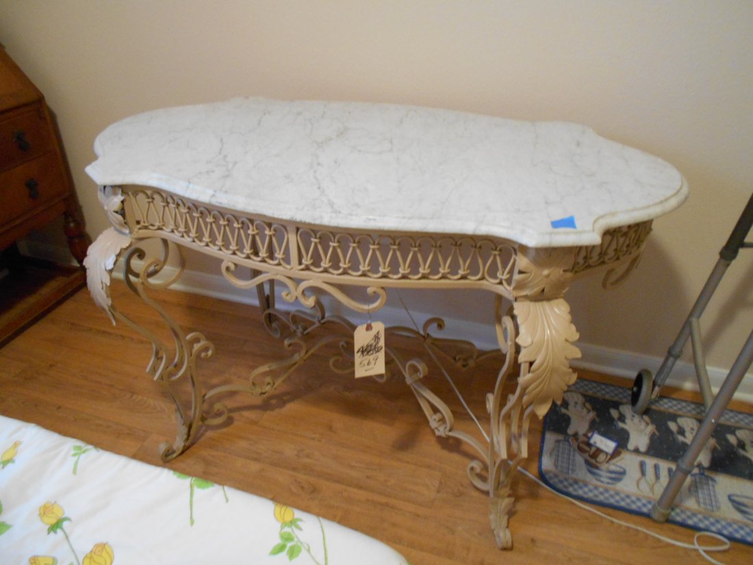 French Provincial Style Garden Table – Furniture.: French provincial style garden table. White marble turtle top. Metal has been painted beige. Lots of curves and fret work. Heavy construction for indoors or out. 31 3/4” tall x 27 3/4” wide x 51��