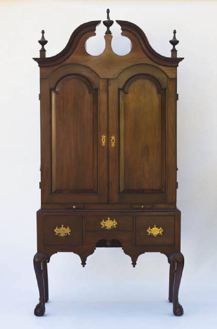 MAHOGANY DESK ON THREE-DRAWER BASE American: MAHOGANY DESK ON THREE-DRAWER BASE American Chippendale, two sections, cabriole legs with claw and ball feet, scalloped apron, case with three short drawers, top section with two arched paneled doors,