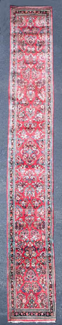 LARGE PERSIAN RUNNER Oriental rug, red field with: LARGE PERSIAN RUNNER Oriental rug, red field with florals in blues and beige, three borders, 21' 4" x 33".