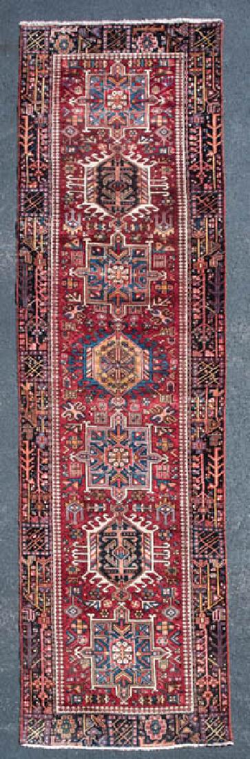 PERSIAN KARAJAH RUNNER Oriental rug, red field with: PERSIAN KARAJAH RUNNER Oriental rug, red field with seven medallions in dark and light blue, yellow central medallion, 3' 6" x 12' 2".