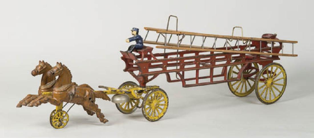 EARLY CAST IRON FIRE WAGON Horse drawn, hook and ladder: EARLY CAST IRON FIRE WAGON Horse drawn, hook and ladder fire wagon with driver in blue, wood ladders, bell, red, yellow and brown paint, 8" h, 26" l.