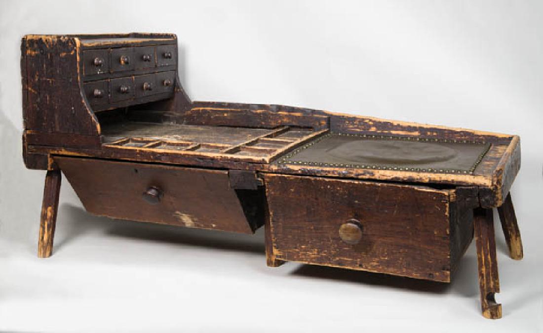 EARLY NEW ENGLAND 19TH C. COBBLER'S BENCH Pine,: EARLY NEW ENGLAND 19TH C. COBBLER'S BENCH Pine, original red/brown painted finish, two large storage drawers below, eight small drawers in two banks above, with wood pulls (renailed), includes large c