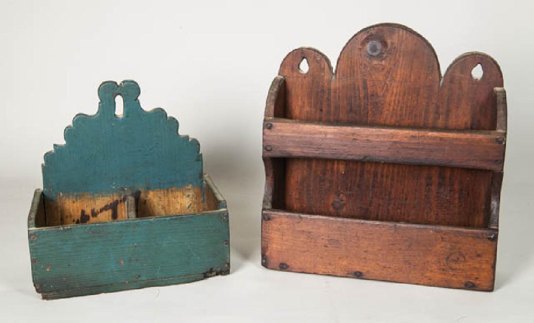 TWO HANGING 19TH C. PINE SHELVES Double shelf with: TWO HANGING 19TH C. PINE SHELVES Double shelf with scalloped top, constructed with rosehead nails, 13" h, 12" w; Decorative cut top in an old blue paint, medial partition, 10" h, 9 3/4" w.