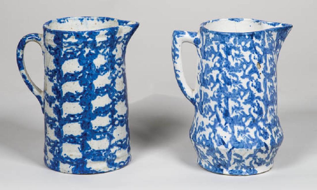 TWO ANTIQUE SPONGEWARE PITCHERS Deep blue decoration,: TWO ANTIQUE SPONGEWARE PITCHERS Deep blue decoration, small imperfections, (one with age line on side), 8 3/4" h.