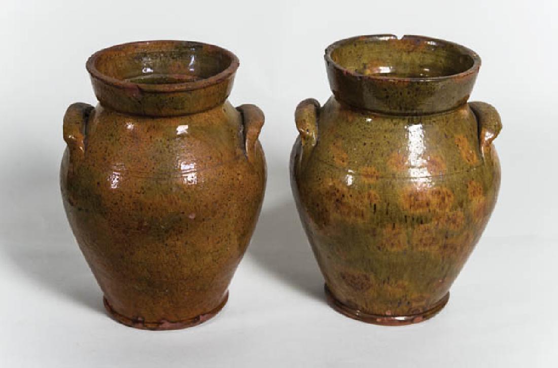 TWO 19TH C. OVOID REDWARE CROCKS New Hampshire, flared: TWO 19TH C. OVOID REDWARE CROCKS New Hampshire, flared rims (minor chipping), orange and green glaze with spattered brown specks, incised lines at handles, 9 3/4" and 10" h, (ex. Curry collection).
