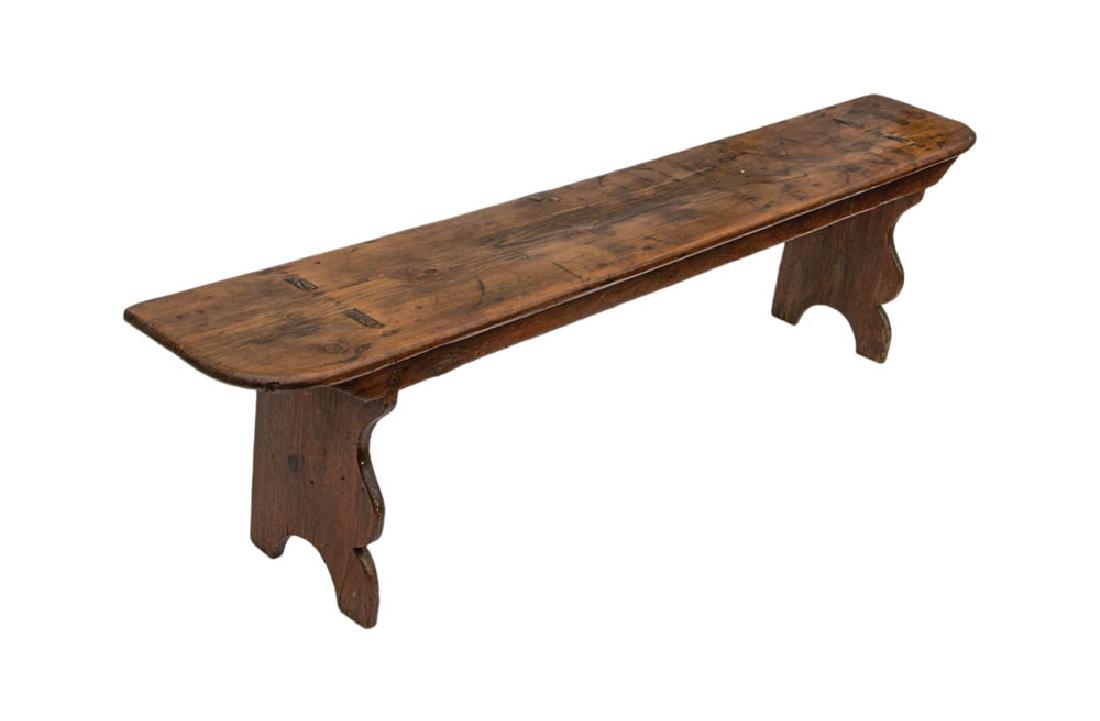 19TH C. PINE BENCH Curved front sides, arched and: 19TH C. PINE BENCH Curved front sides, arched and cutout leg, double through mortised top board, 18" h, 6' l, 11 1/2" w.