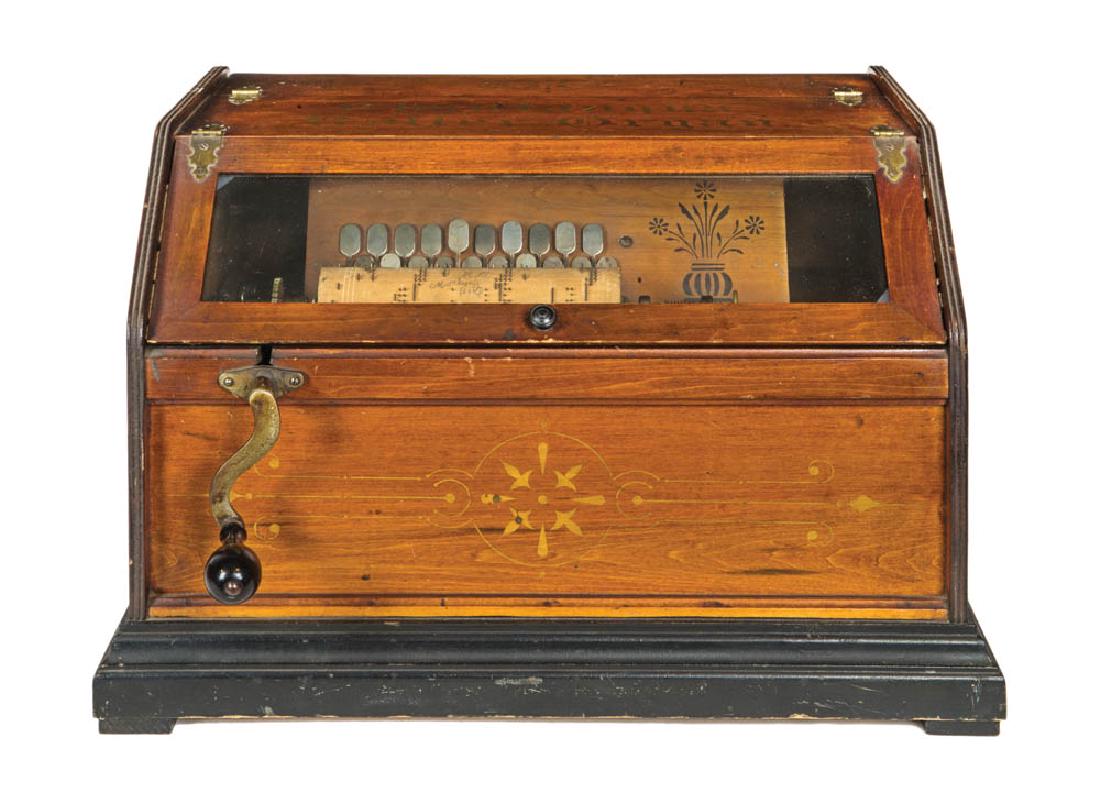 TWO MUSIC BOXES Swiss box with eight tunes, dated 1882,: TWO MUSIC BOXES Swiss box with eight tunes, dated 1882, lid shows some scratches, 5" h, 13" w, 8" d; "Chautauqua Roller Organ", with box of rolls; both from a South Shore Historical Society.