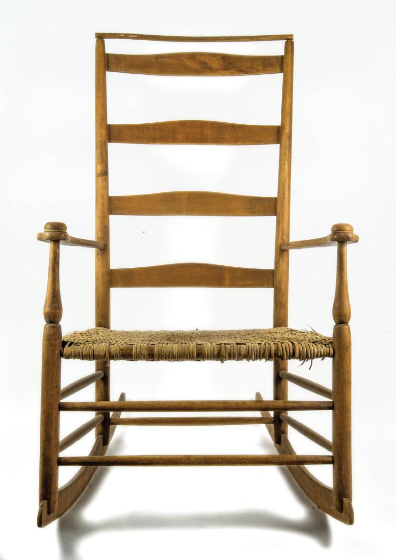 19TH C. SHAKER PRODUCTION ROCKING CHAIR: 19TH C. SHAKER PRODUCTION ROCKING CHAIR Mt. Lebanon, NY, "7" (stamped on back of top slat), shawl bar over four slats, curvilinear arms with mushroom caps, woven cane seat, old refinish, 15" seat h, 4
