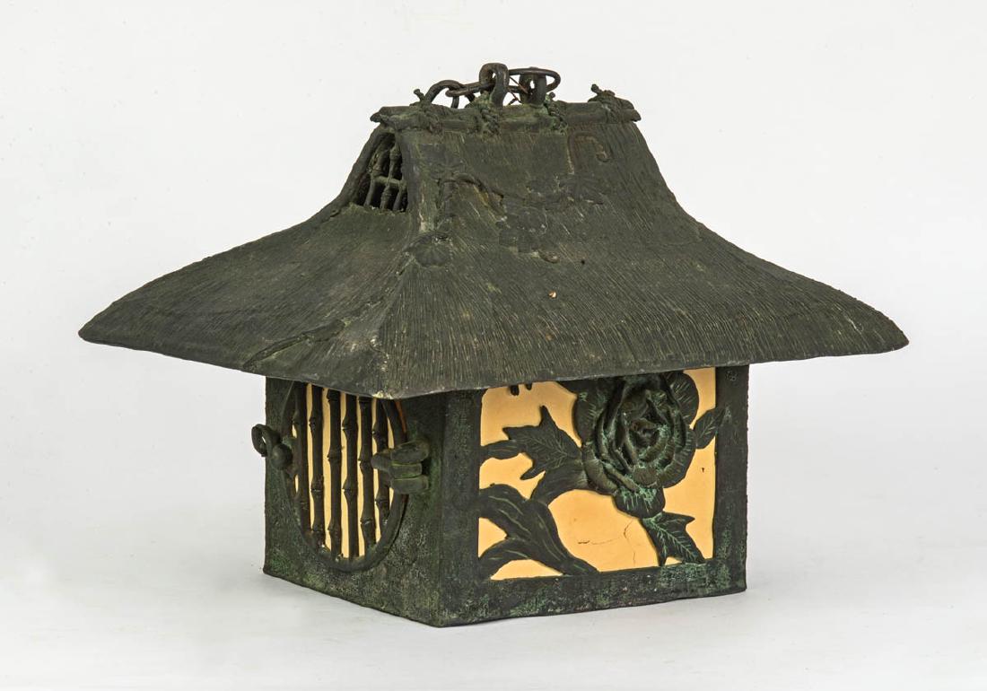 EARLY 20TH C. JAPANESE HANGING LIGHT: EARLY 20TH C. JAPANESE HANGING LIGHT Bronze, pagoda with thatched roof, sides decorated with flowers and cherry blossom limb, circular sides with slats, 12" h, 15" w.