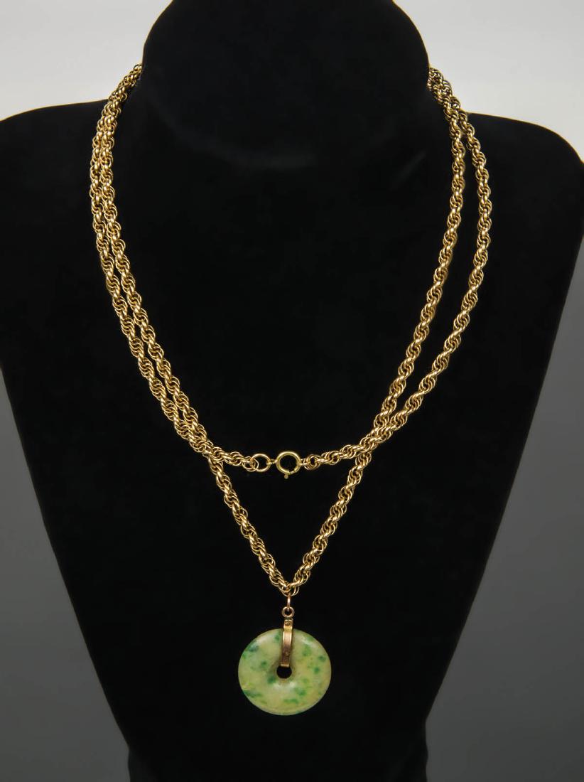 NECKLACE WITH PENDANT: NECKLACE WITH PENDANT 14K yellow gold necklace, with jade "Bi" circle pendant, 25.68 gms, 31" l.