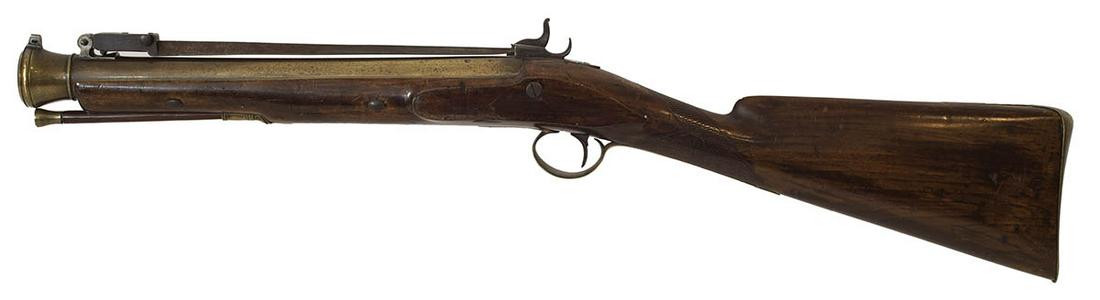 BRITISH COACH GUN, BLUNDERBUSS WITH BAYONETPercussion: BRITISH COACH GUN, BLUNDERBUSS WITH BAYONETPercussion Blunderbuss with built-in bayonet, hallmarked on top of brass barrel, with "Lowe Chester" engraved maker's mark, engraved trigger guard and lock