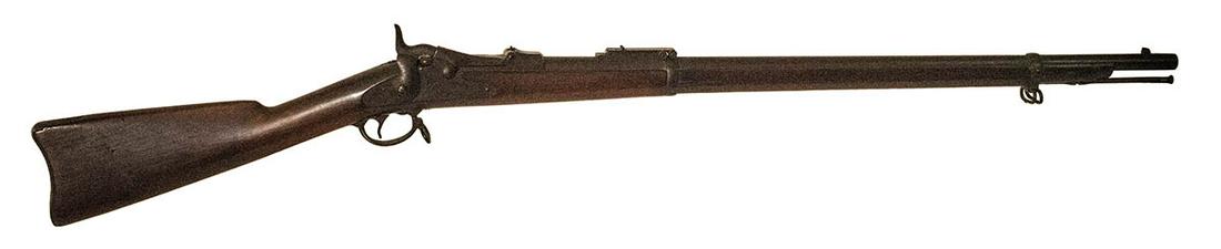 TRAP DOOR RIFLE, .45/.70 CAL"U.S. Springfield, US Model: TRAP DOOR RIFLE, .45/.70 CAL"U.S. Springfield, US Model 1884" trap door rifle, serial #564245, lightly carved "initials and 1893" in side of stock, stock has a tight crack on one side, and wear, 30% o