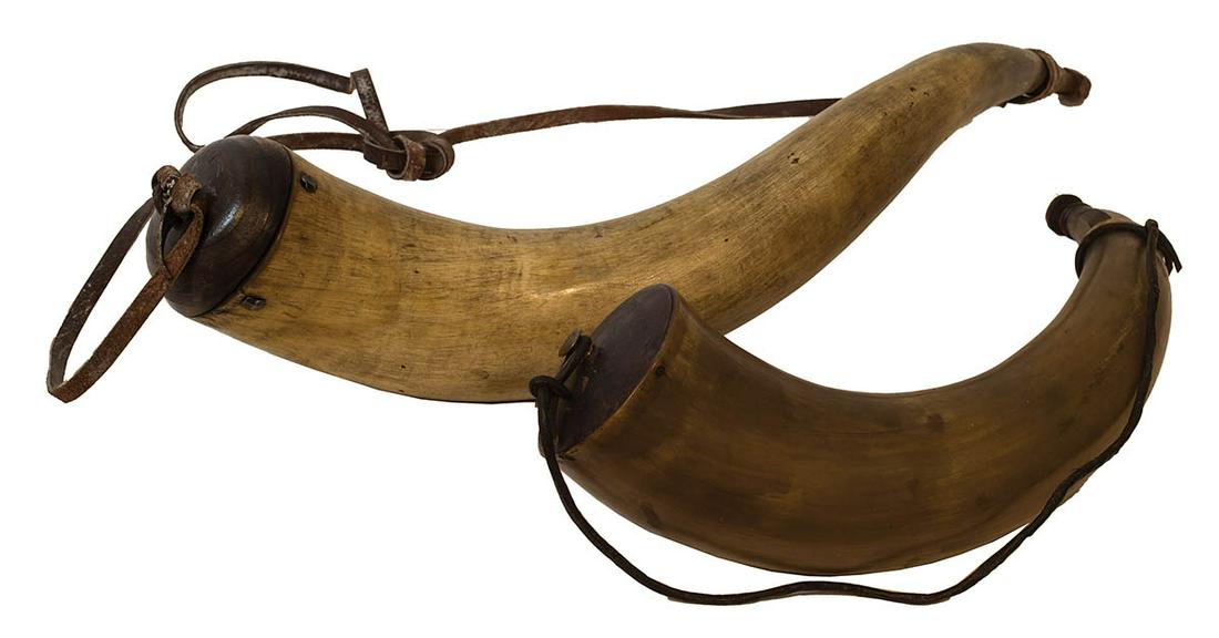 TWO POWDER HORNSA 16" l horn; and a 22 1/2" l large: TWO POWDER HORNSA 16" l horn; and a 22 1/2" l large horn, with hand forged tacks securing the base plug, wear, and minor damage (mostly moth holes).