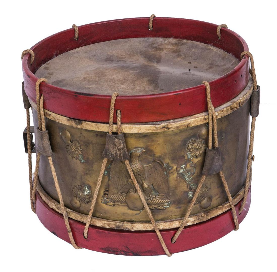 MILITARY DRUMDrum with a brass shell, and a 4 3/4": MILITARY DRUMDrum with a brass shell, and a 4 3/4" repousse eagle, framed by four repousse fire bombs, this rope tension drum has wear and the skins are not stretched, 11 3/4" h, 15 3/4" dia.
