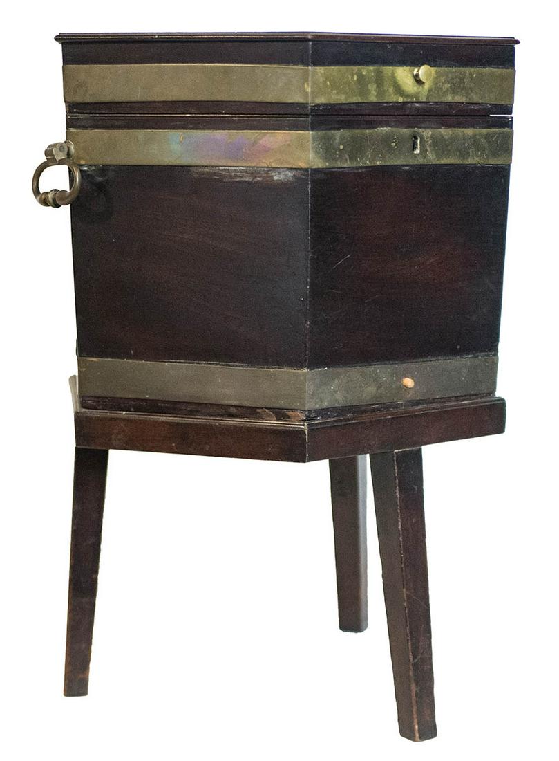19TH C. WINE CHESTHexagonal, brass bound mahogany, wine: 19TH C. WINE CHESTHexagonal, brass bound mahogany, wine chest on separate stand, cast brass handles, square tapered legs, with key (lock missing), 26" h, 20" w.