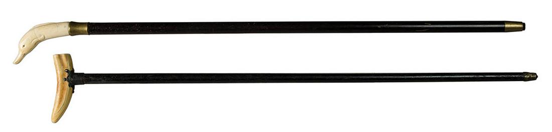 TWO CANESDark wood tapered cane, with a carved: TWO CANESDark wood tapered cane, with a carved whalebone dolphin end with black bead eyes, a brass tipped wooden shaft, with wear and age cracks in dolphin, 35" l; Dark wood tapered cane, with a boar'
