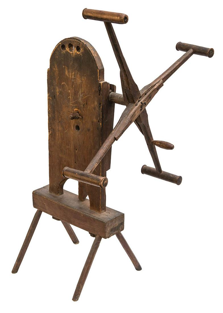 18TH C. NEW ENGLAND YARN WINDERPine, rosehead nails,: 18TH C. NEW ENGLAND YARN WINDERPine, rosehead nails, block pedestal base, with four splayed legs, three carrying holes, with mid 19th c. reinforced repairs to carved arms.